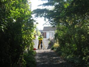 Photograph shows our surveyor using Total station instrument taking measurement of the important boundary features as part of Boundary Survey Report for a private off New Forge Lane. More complicated with number of neighbouring properties.